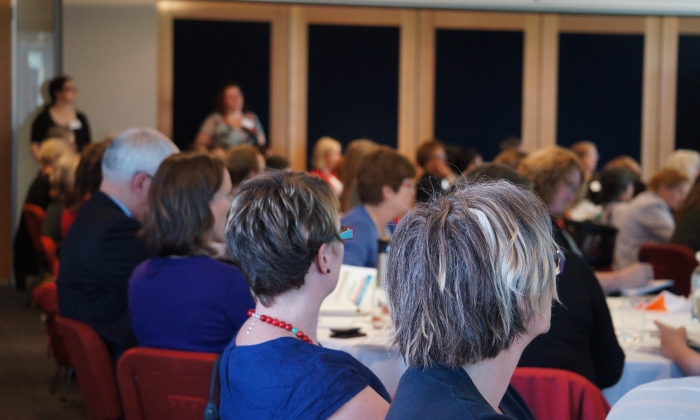 A group of people attending a forum.